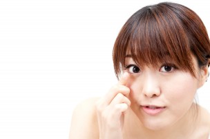 beautiful asian woman taking care of her eye